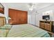 Well-lit bedroom with a ceiling fan, wood trim, and closet at 2261 Swedish Dr # 47, Clearwater, FL 33763