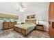 Comfortable bedroom with wood-look floors, ceiling fan, and natural light from the window at 2261 Swedish Dr # 47, Clearwater, FL 33763