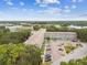 Aerial view of a bright condominium complex surrounded by lush greenery under clear blue skies at 2261 Swedish Dr # 47, Clearwater, FL 33763