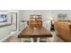 Spacious dining area showcasing a large wooden table with seating for six, adjacent to a modern kitchen at 2261 Swedish Dr # 47, Clearwater, FL 33763