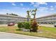 Well-maintained condo complex with mature landscaping, signage, and convenient parking on a sunny day at 2261 Swedish Dr # 47, Clearwater, FL 33763