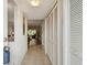 Inviting hallway with tiled floor, coat closet, and view of the living room at 2261 Swedish Dr # 47, Clearwater, FL 33763