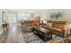 Open concept living area with hardwood flooring, leather sofas, and a view into the dining area at 2261 Swedish Dr # 47, Clearwater, FL 33763
