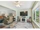 Spacious living area featuring a fireplace, large TV, and seamless flow to other living spaces at 2261 Swedish Dr # 47, Clearwater, FL 33763
