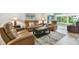 Relaxing living room featuring plush leather seating, stylish decor, and a seamless transition to the sunroom at 2261 Swedish Dr # 47, Clearwater, FL 33763