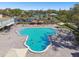 Overhead shot of a uniquely shaped swimming pool featuring shaded seating areas and lush landscaping in a vibrant community at 2261 Swedish Dr # 47, Clearwater, FL 33763
