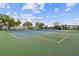 Well-maintained tennis courts provide recreational opportunities, set against a backdrop of community buildings and lush trees at 2261 Swedish Dr # 47, Clearwater, FL 33763
