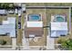 Aerial view of a fenced property featuring a screened-in pool and a well-maintained lawn at 260 Venice East Blvd, Venice, FL 34293