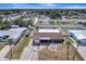 Aerial view of a home with a screened-in pool and a well-kept lawn, nestled in a friendly neighborhood at 260 Venice East Blvd, Venice, FL 34293