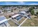 Aerial view of a fenced-in backyard featuring a screened-in pool and lush green lawn at 260 Venice East Blvd, Venice, FL 34293