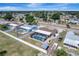 Wide aerial view shows the property with a screened pool, landscaped yard in a serene, residential setting at 260 Venice East Blvd, Venice, FL 34293