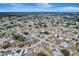 An aerial view showing a home, its surrounding neighborhood, and coastal landscapes at 260 Venice East Blvd, Venice, FL 34293