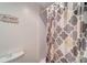 Clean bathroom featuring a toilet, shower, and bathtub at 260 Venice East Blvd, Venice, FL 34293