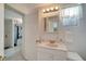 Well-lit bathroom features classic vanity, neutral tile and fixtures, offering a clean functional space at 260 Venice East Blvd, Venice, FL 34293