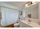 Bright bathroom with a shower and tub combination, and a white vanity at 260 Venice East Blvd, Venice, FL 34293