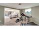 Bright bedroom featuring exercise equipment and sliding door access to the pool area at 260 Venice East Blvd, Venice, FL 34293