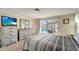 Bright bedroom features natural lighting, carpeting, and a sliding glass door to the enclosed lanai at 260 Venice East Blvd, Venice, FL 34293