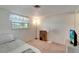 Bright bedroom with carpet, window, and a television at 260 Venice East Blvd, Venice, FL 34293
