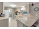 Efficient kitchen features white appliances and counter seating at 260 Venice East Blvd, Venice, FL 34293
