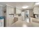 Bright kitchen with ample cabinet space and a view of the laundry area at 260 Venice East Blvd, Venice, FL 34293