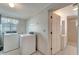 Functional laundry room with a bathroom entrance at 260 Venice East Blvd, Venice, FL 34293