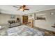 Cozy living room with tile flooring, a fireplace, and access to a small kitchen and dining room at 260 Venice East Blvd, Venice, FL 34293