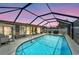 Inviting pool with a screened enclosure, seating and grill at 260 Venice East Blvd, Venice, FL 34293