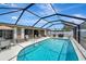 Inviting screened-in pool with ample patio space for lounging and entertaining, complete with a grill at 260 Venice East Blvd, Venice, FL 34293