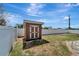 Modern shed in a fenced backyard offers extra storage space at 260 Venice East Blvd, Venice, FL 34293