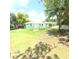 Wide angle shot of a green single story home with a spacious backyard at 27752 Ravens Brook Rd, Wesley Chapel, FL 33544