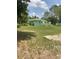 Sprawling backyard offering a serene view of the home's rear exterior and surrounding landscape at 27752 Ravens Brook Rd, Wesley Chapel, FL 33544