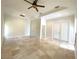 Bedroom featuring marble tile floors, closet and patio access at 27752 Ravens Brook Rd, Wesley Chapel, FL 33544