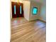 Inviting entryway features a beautiful wood door and light wood-style floors at 27752 Ravens Brook Rd, Wesley Chapel, FL 33544