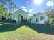 Attractive single-story home features a lush front lawn, arched entryway, double doors, and well maintained landscaping at 27752 Ravens Brook Rd, Wesley Chapel, FL 33544