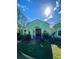 Inviting single-story home features an arched entryway, double doors, lush lawn, and professionally landscaped garden at 27752 Ravens Brook Rd, Wesley Chapel, FL 33544