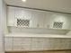 Updated kitchen with white cabinets and a long counter space at 27752 Ravens Brook Rd, Wesley Chapel, FL 33544
