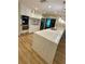 Modern kitchen features quartz countertop and breakfast bar seating at 27752 Ravens Brook Rd, Wesley Chapel, FL 33544