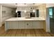 Gourmet kitchen features a large island and modern lighting at 27752 Ravens Brook Rd, Wesley Chapel, FL 33544