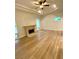 Large living room with tray ceilings, a fireplace and light floors at 27752 Ravens Brook Rd, Wesley Chapel, FL 33544