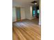 Bright living room with wood style floors and adjacent mirrored wall at 27752 Ravens Brook Rd, Wesley Chapel, FL 33544