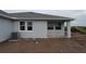 The backyard of a new construction house with grey siding and bright white trim at 2824 Marrakesh Ln, Sarasota, FL 34234