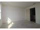 Unfinished primary bedroom with a window for natural light and doorway to bathroom at 2824 Marrakesh Ln, Sarasota, FL 34234