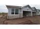New construction home with stone accents around a large window and an open two-car garage at 2824 Marrakesh Ln, Sarasota, FL 34234