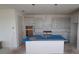 Modern kitchen with a central island, stainless steel appliances, and stylish pendant lighting at 2824 Marrakesh Ln, Sarasota, FL 34234