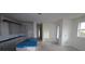 A newly built kitchen with white cabinets, a large island, and stainless steel appliances at 2824 Marrakesh Ln, Sarasota, FL 34234
