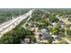 Stunning aerial shot of a neighborhood next to the highway; the house is marked with a yellow arrow at 2825 N Taliaferro N Ave, Tampa, FL 33602