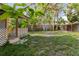 Spacious backyard with trees, wooden fence, and covered patio at 2825 N Taliaferro N Ave, Tampa, FL 33602
