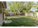 Spacious backyard with a wooden fence, some trees and a small structure at 2825 N Taliaferro N Ave, Tampa, FL 33602
