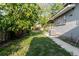 Large backyard with the side of the house featuring a window and an AC Unit at 2825 N Taliaferro N Ave, Tampa, FL 33602