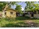 Large backyard with a shed and trees, providing ample space and shade at 2825 N Taliaferro N Ave, Tampa, FL 33602
